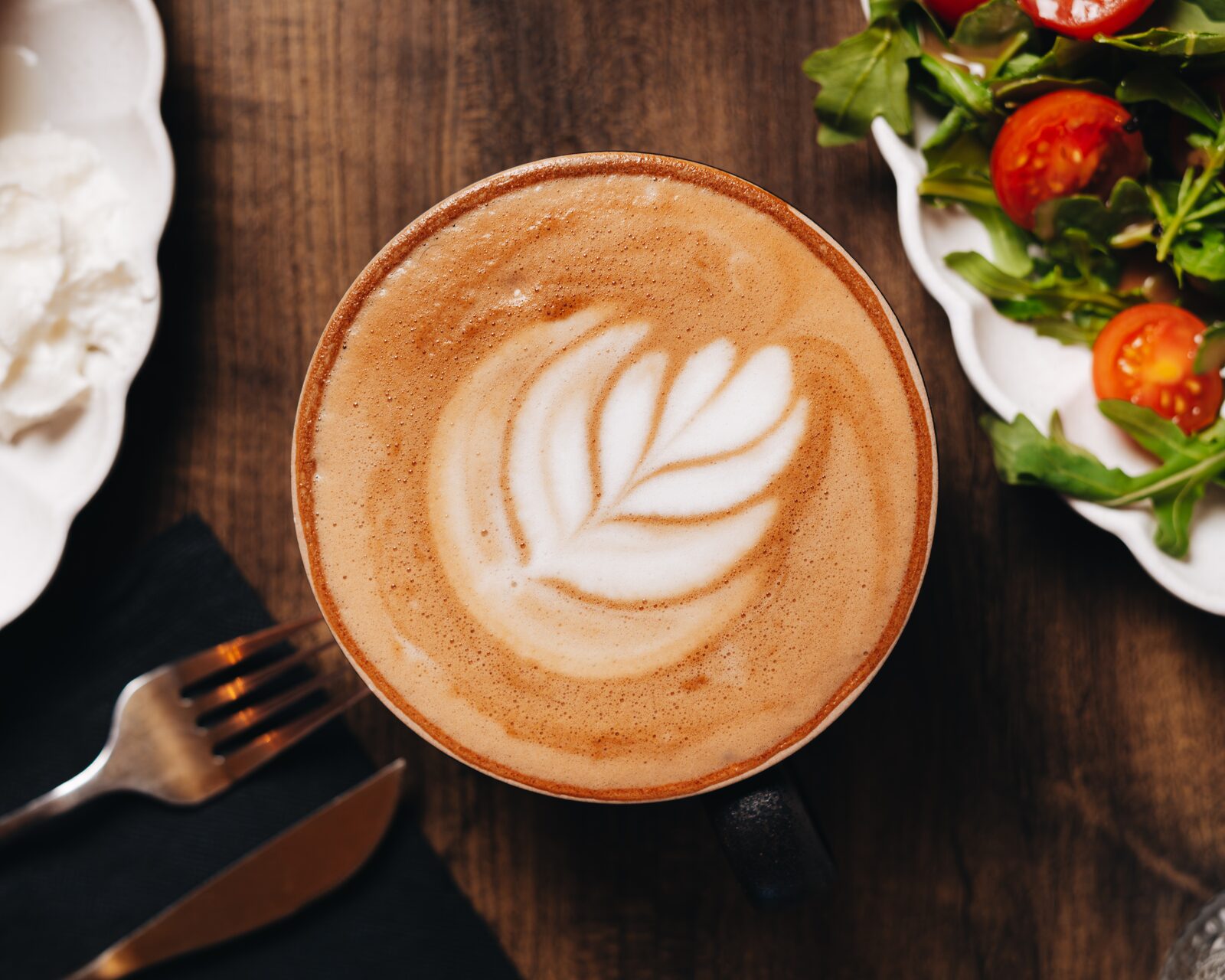 Latte with rosetta art from above