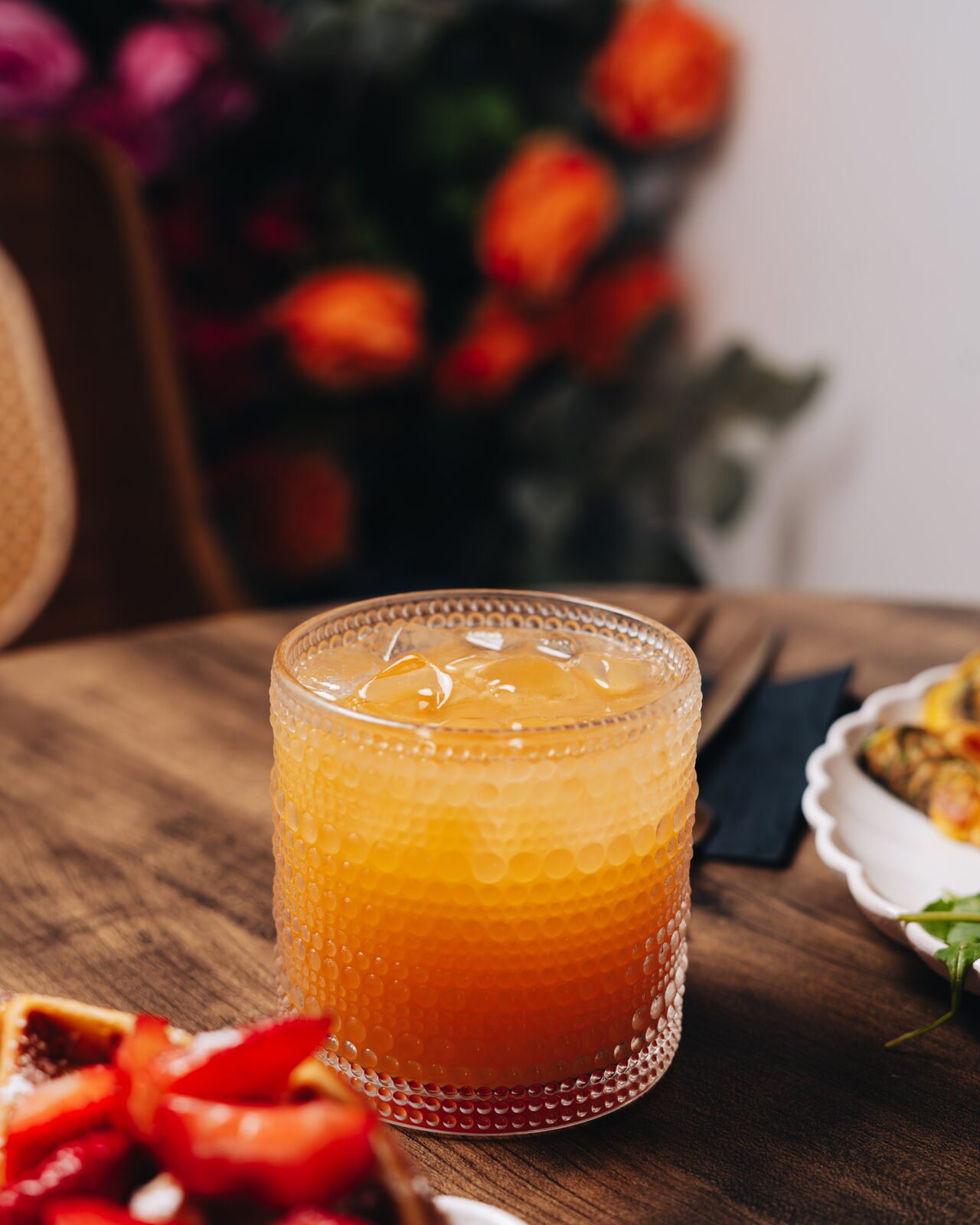 Iced mimosa in textured glass with floral backdrop