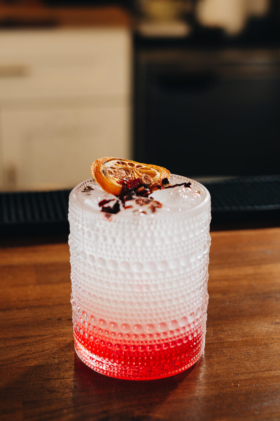 Signature cocktail with dried orange and hibiscus